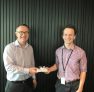 Auckland Partner Chris Bargery presenting New World Vouchers to Josh from the Auckland City Mission
